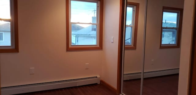 interior space featuring dark hardwood / wood-style flooring and a baseboard heating unit