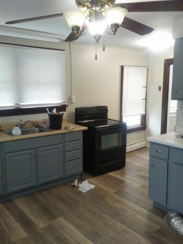 kitchen with electric range, sink, ceiling fan, baseboard heating, and dark hardwood / wood-style floors