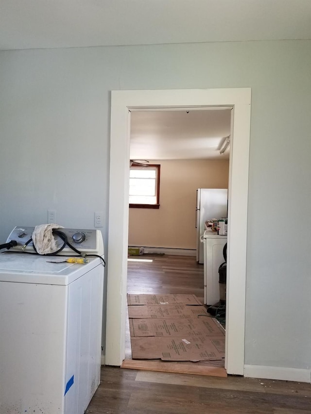 clothes washing area featuring washer / clothes dryer and dark hardwood / wood-style floors