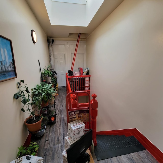 staircase featuring hardwood / wood-style flooring and a skylight