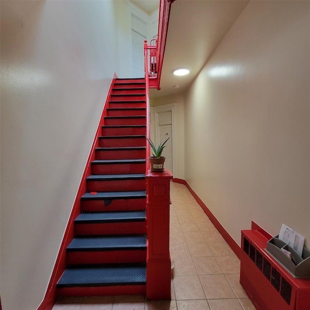 stairway featuring tile patterned flooring