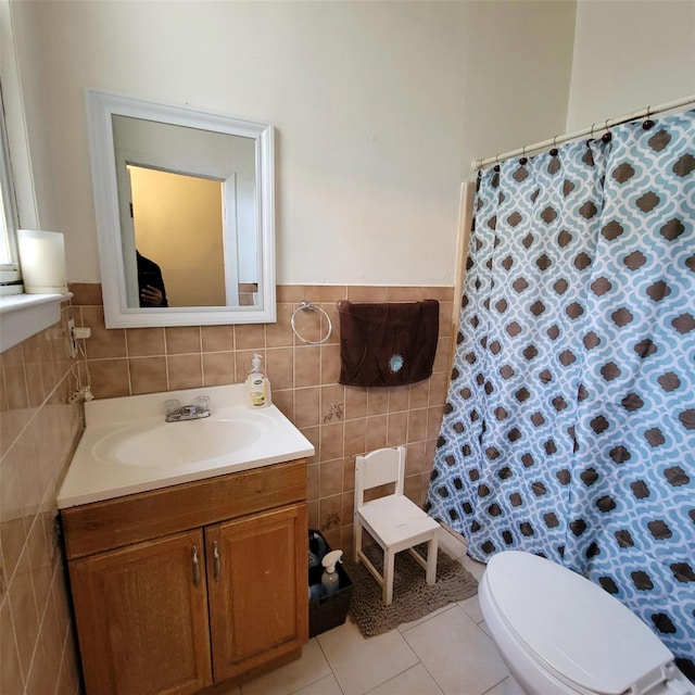 bathroom featuring tile patterned floors, toilet, vanity, tile walls, and a shower with shower curtain