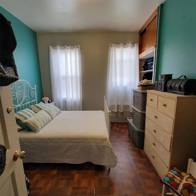 bedroom with dark parquet floors