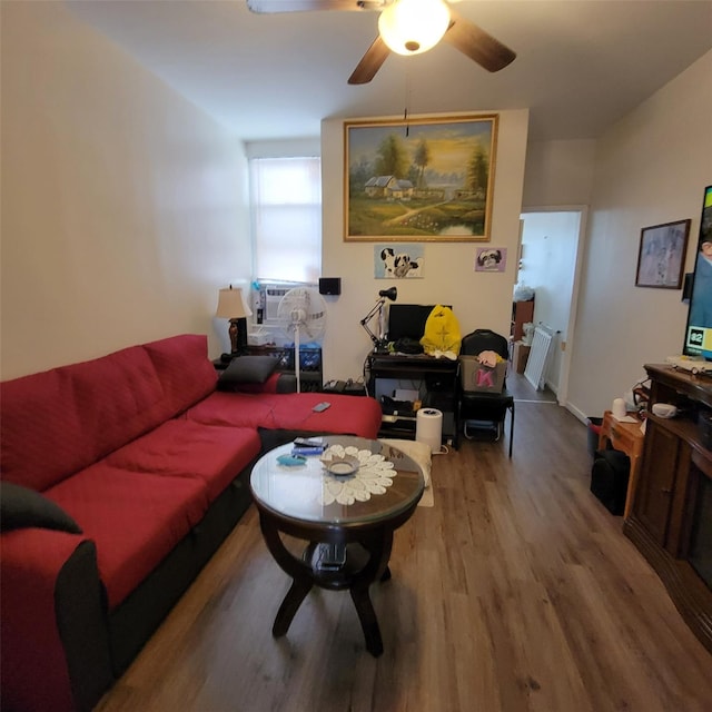 living room with light hardwood / wood-style flooring, ceiling fan, and cooling unit