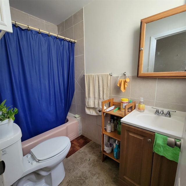 full bathroom featuring vanity, toilet, tile walls, and shower / tub combo with curtain