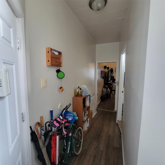 corridor with dark hardwood / wood-style flooring