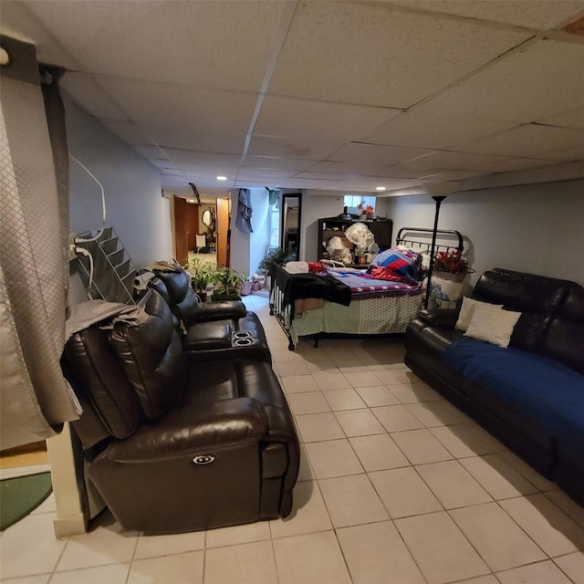 bedroom with a drop ceiling and light tile patterned flooring