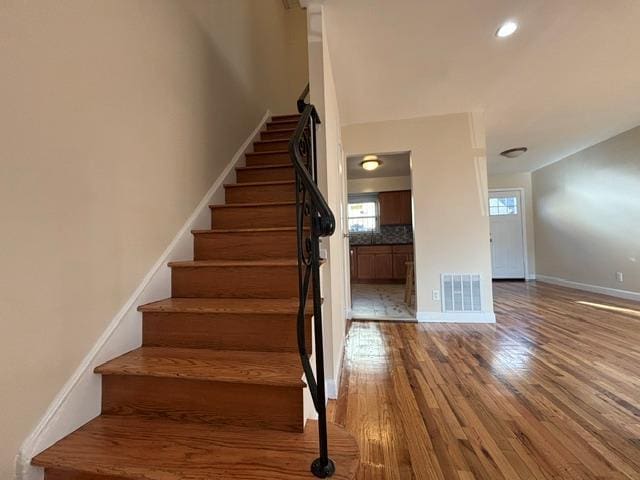 staircase featuring hardwood / wood-style flooring