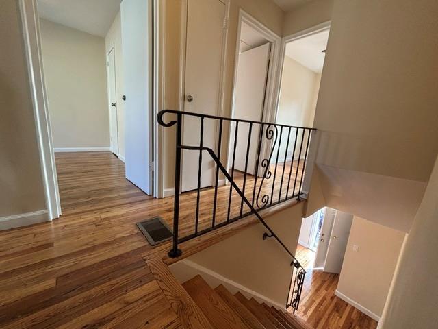 staircase with hardwood / wood-style flooring