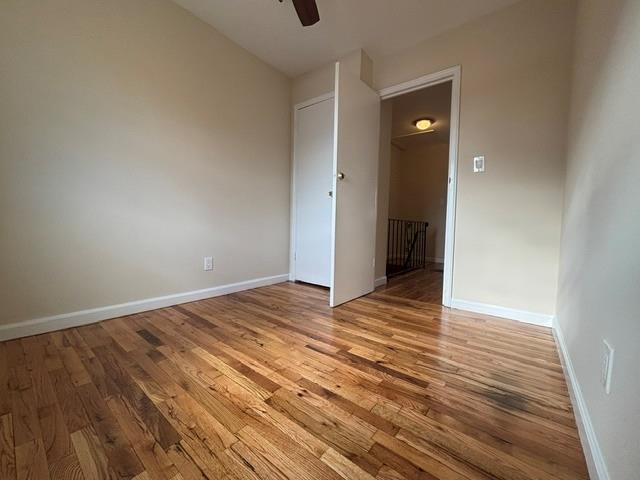 spare room with ceiling fan and hardwood / wood-style floors