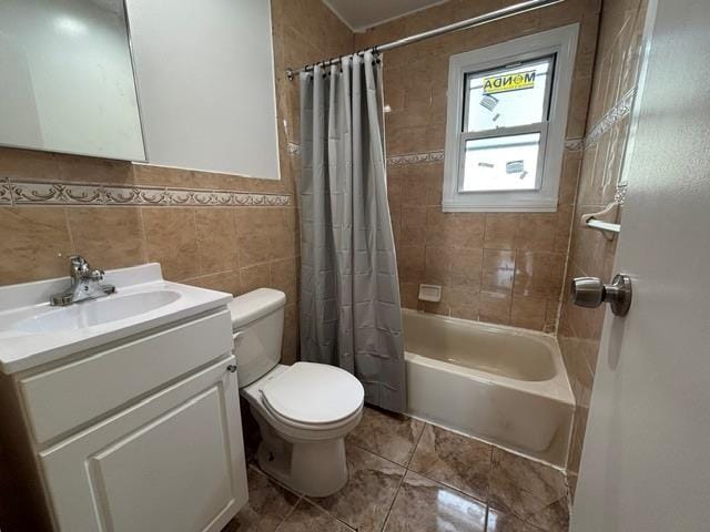 full bathroom with shower / bath combo, vanity, toilet, and tile walls