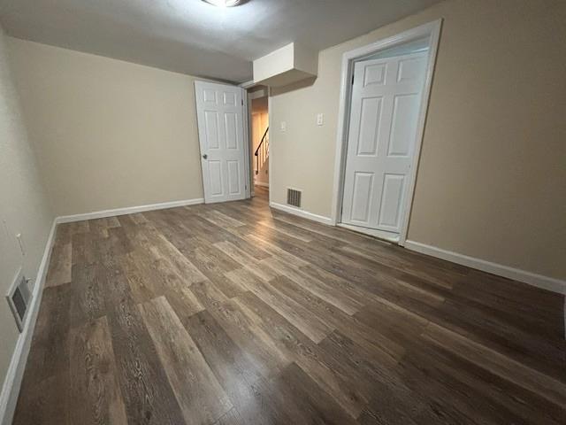 spare room with dark wood-type flooring