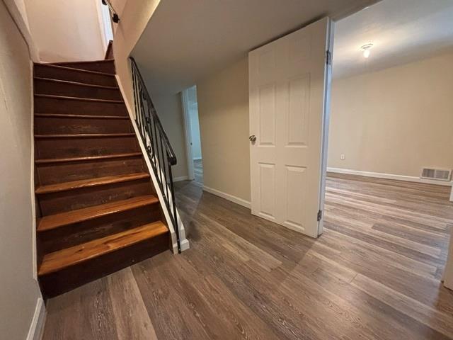 stairs with hardwood / wood-style flooring