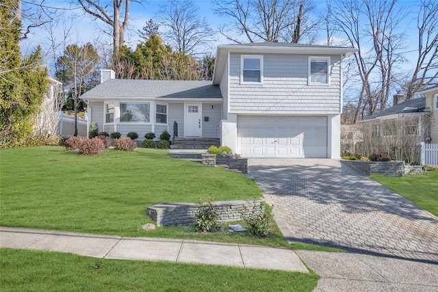 tri-level home featuring a front yard and a garage