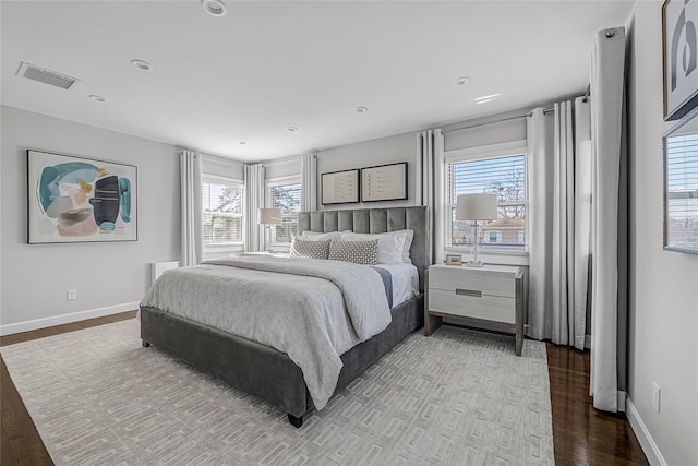 bedroom with light wood-type flooring and multiple windows