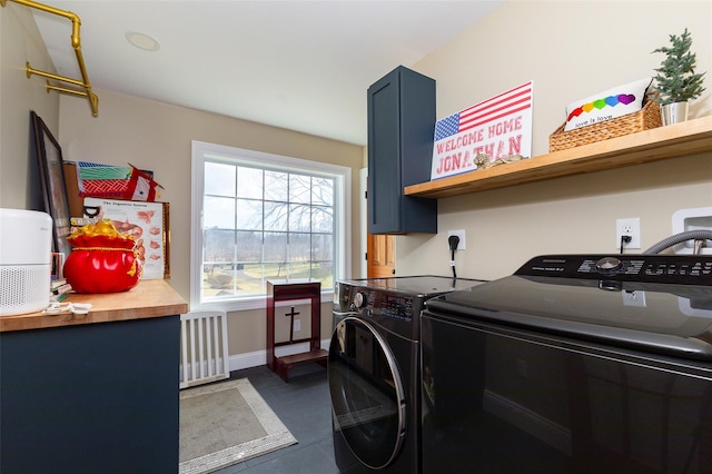 laundry room featuring washing machine and clothes dryer and radiator heating unit