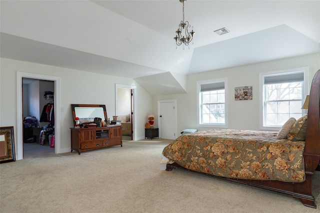 bedroom featuring a spacious closet, a chandelier, vaulted ceiling, light carpet, and a closet