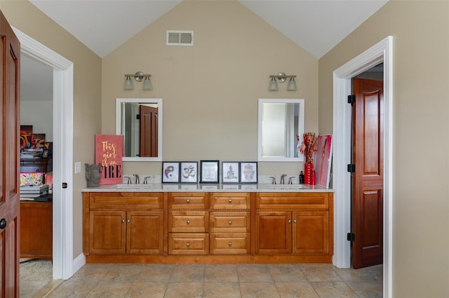 bathroom with vanity and vaulted ceiling