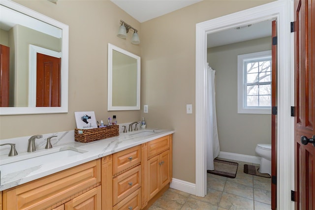 bathroom featuring vanity and toilet