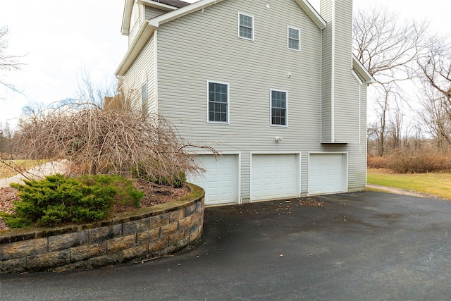 view of side of home with a garage