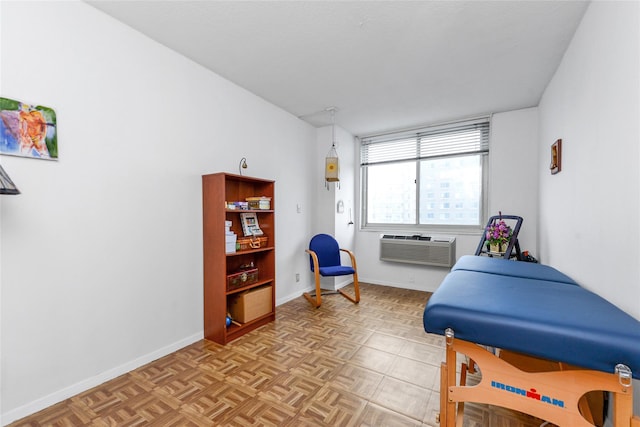 bedroom with an AC wall unit and light parquet floors