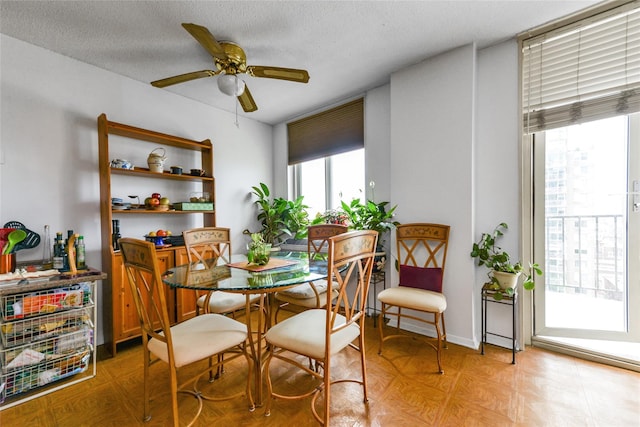 dining room featuring a textured ceiling and ceiling fan