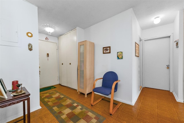 foyer featuring a textured ceiling and electric panel