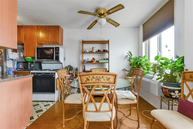 kitchen featuring decorative backsplash, a textured ceiling, white range with gas cooktop, cooling unit, and ceiling fan