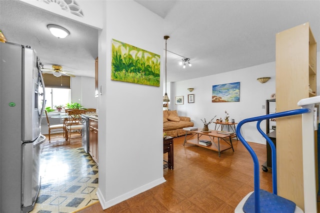 interior space featuring ceiling fan and a textured ceiling