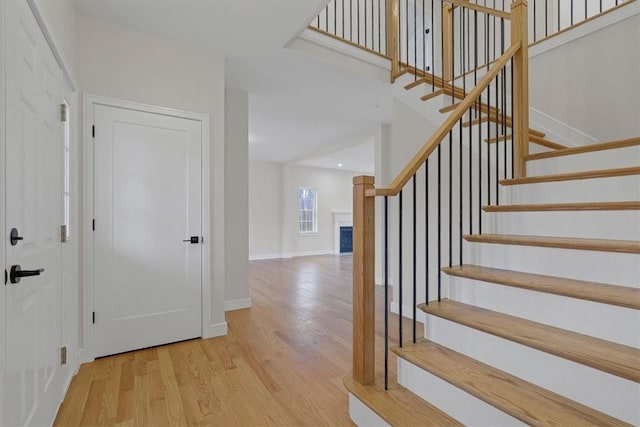 stairway with hardwood / wood-style flooring