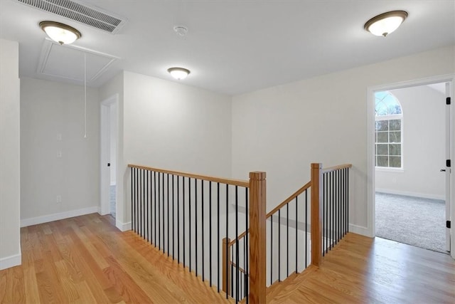 hallway with light hardwood / wood-style floors