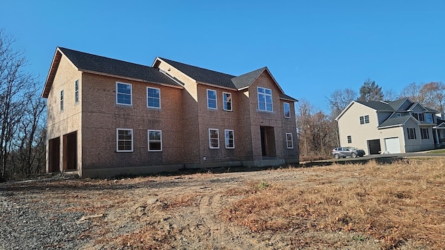 rear view of house with a garage