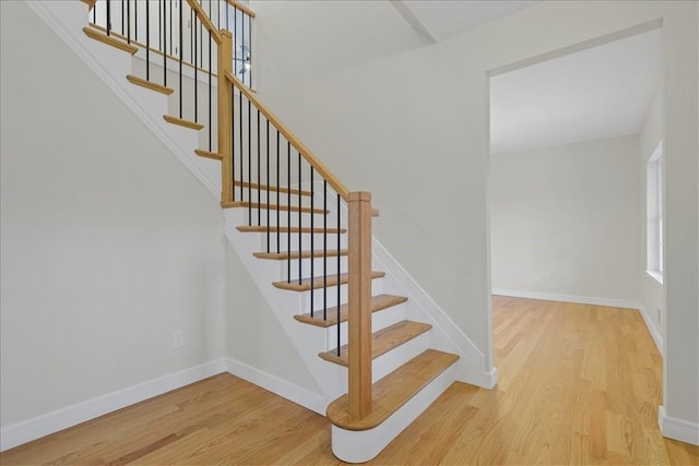 stairs featuring hardwood / wood-style floors