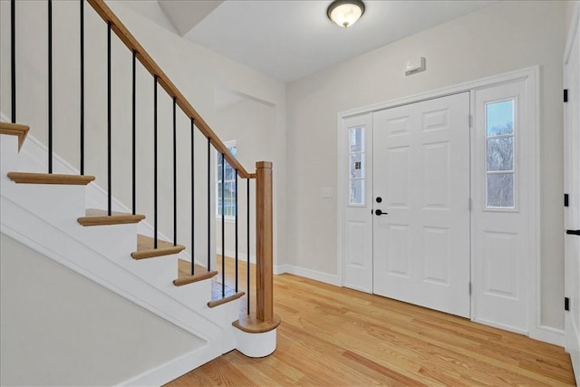 foyer with light wood-type flooring and a wealth of natural light