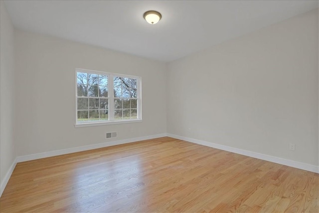 empty room with light hardwood / wood-style flooring