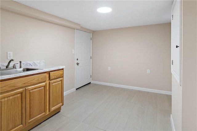 washroom featuring sink and light hardwood / wood-style flooring