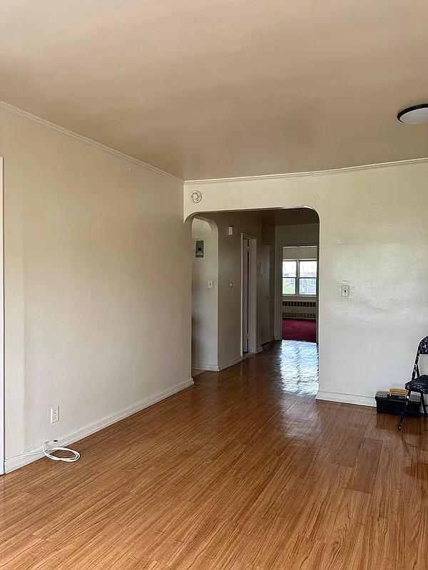 unfurnished room featuring crown molding and hardwood / wood-style flooring