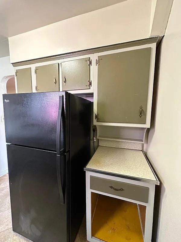 kitchen featuring black refrigerator