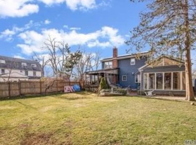 view of yard with a sunroom