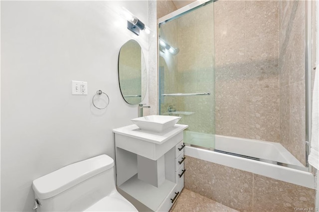 full bathroom with toilet, vanity, and combined bath / shower with glass door