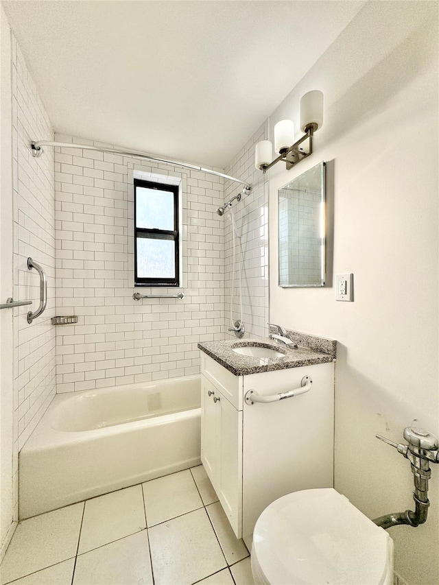 full bathroom featuring tile patterned floors, tiled shower / bath, vanity, and toilet