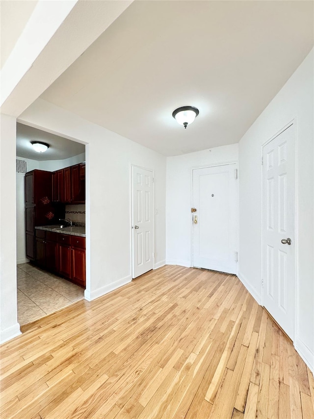 interior space with light hardwood / wood-style floors and sink