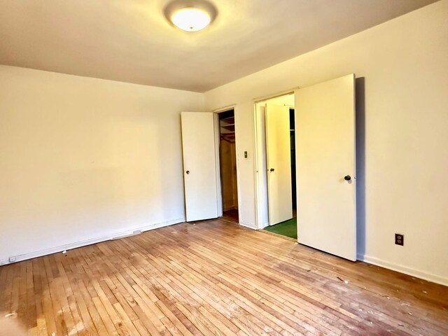 unfurnished bedroom with a closet and light hardwood / wood-style flooring