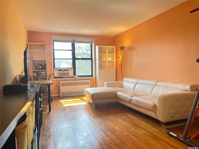 living room featuring light wood-type flooring and radiator