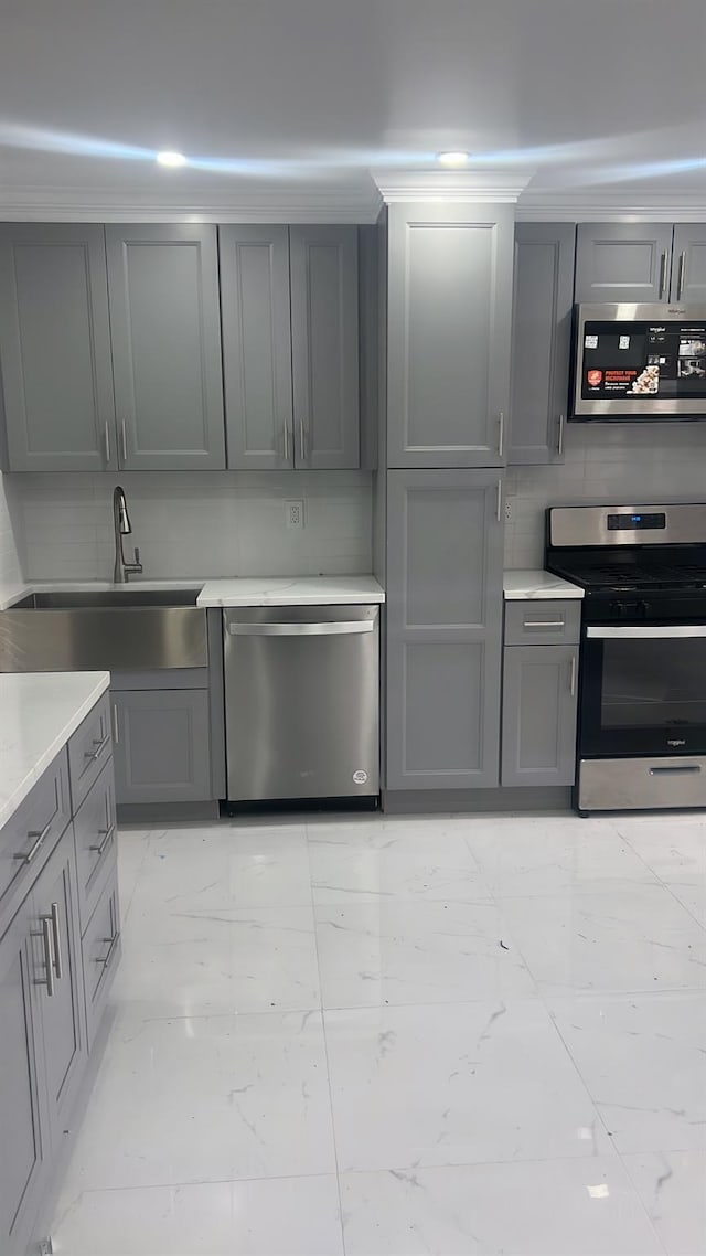 kitchen featuring gray cabinets, sink, and stainless steel appliances