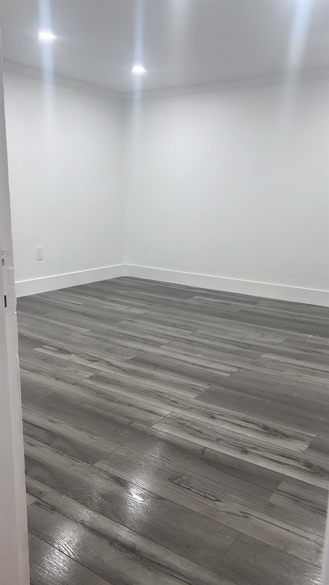 unfurnished room with dark hardwood / wood-style flooring