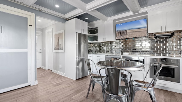 kitchen featuring white cabinets, appliances with stainless steel finishes, and coffered ceiling