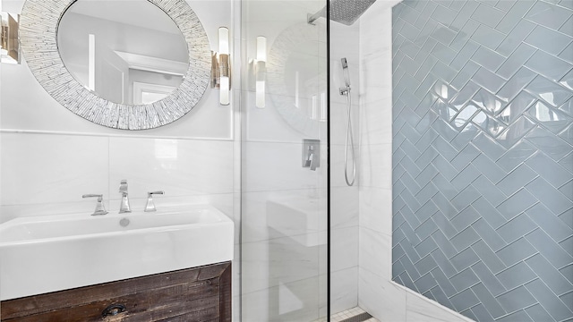 bathroom with vanity and tiled shower