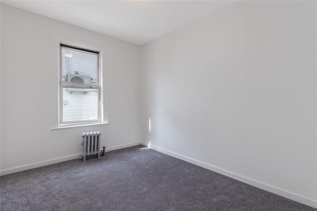 carpeted spare room with radiator