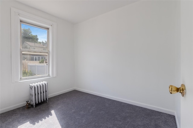 carpeted spare room with radiator heating unit